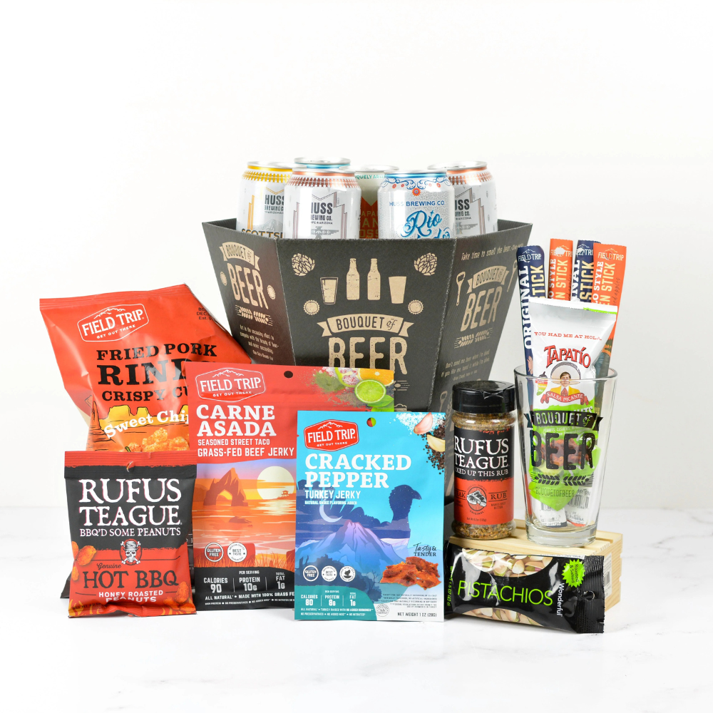 Assorted beer gift basket with food and beverage items including chips, jerky, and drinks on a white background