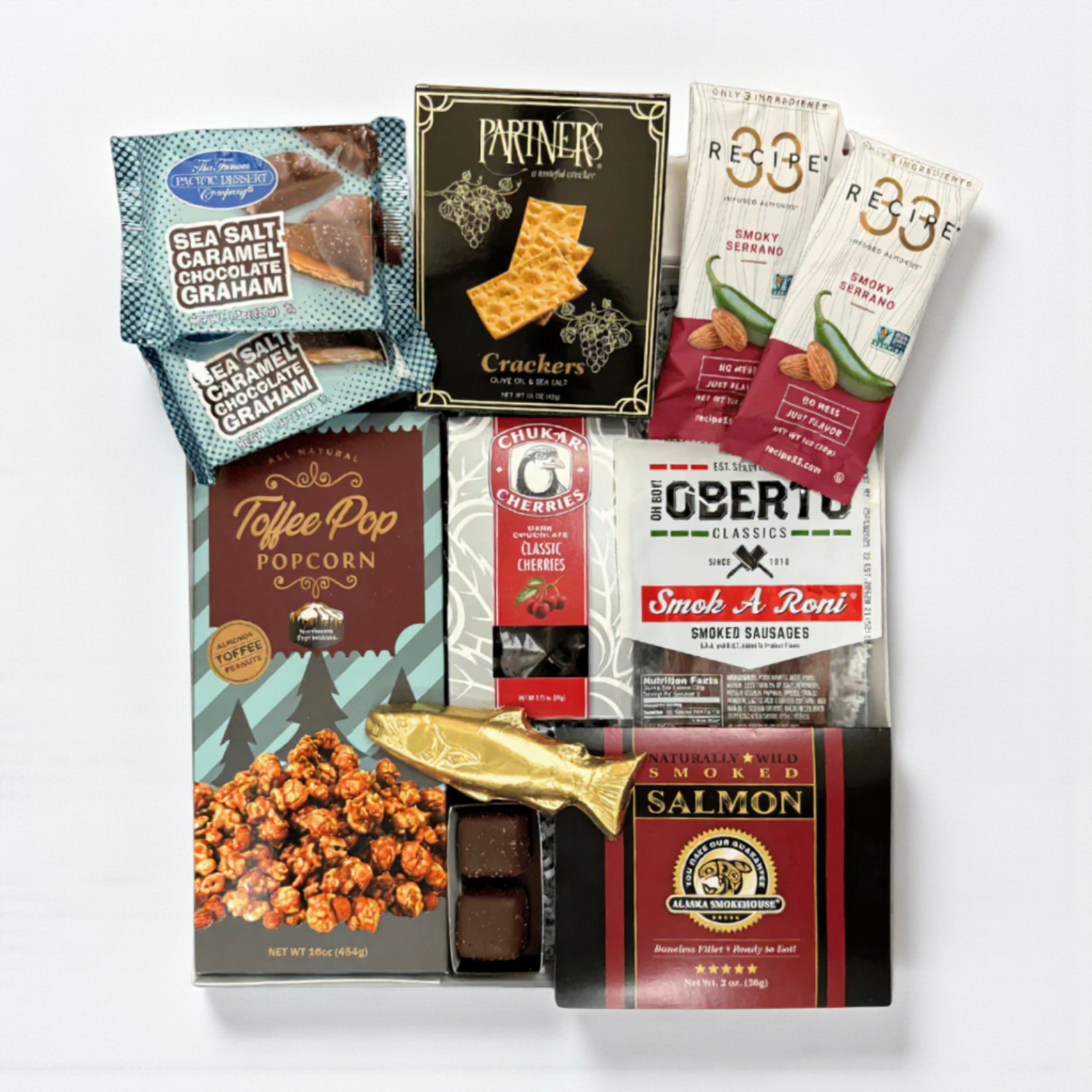 snack box filled with snacks made in WA. The gift box includes: smoked salmon, pepperoni sticks, raosted nuts, crackers chocolate cherries and a solid chocolate salmon