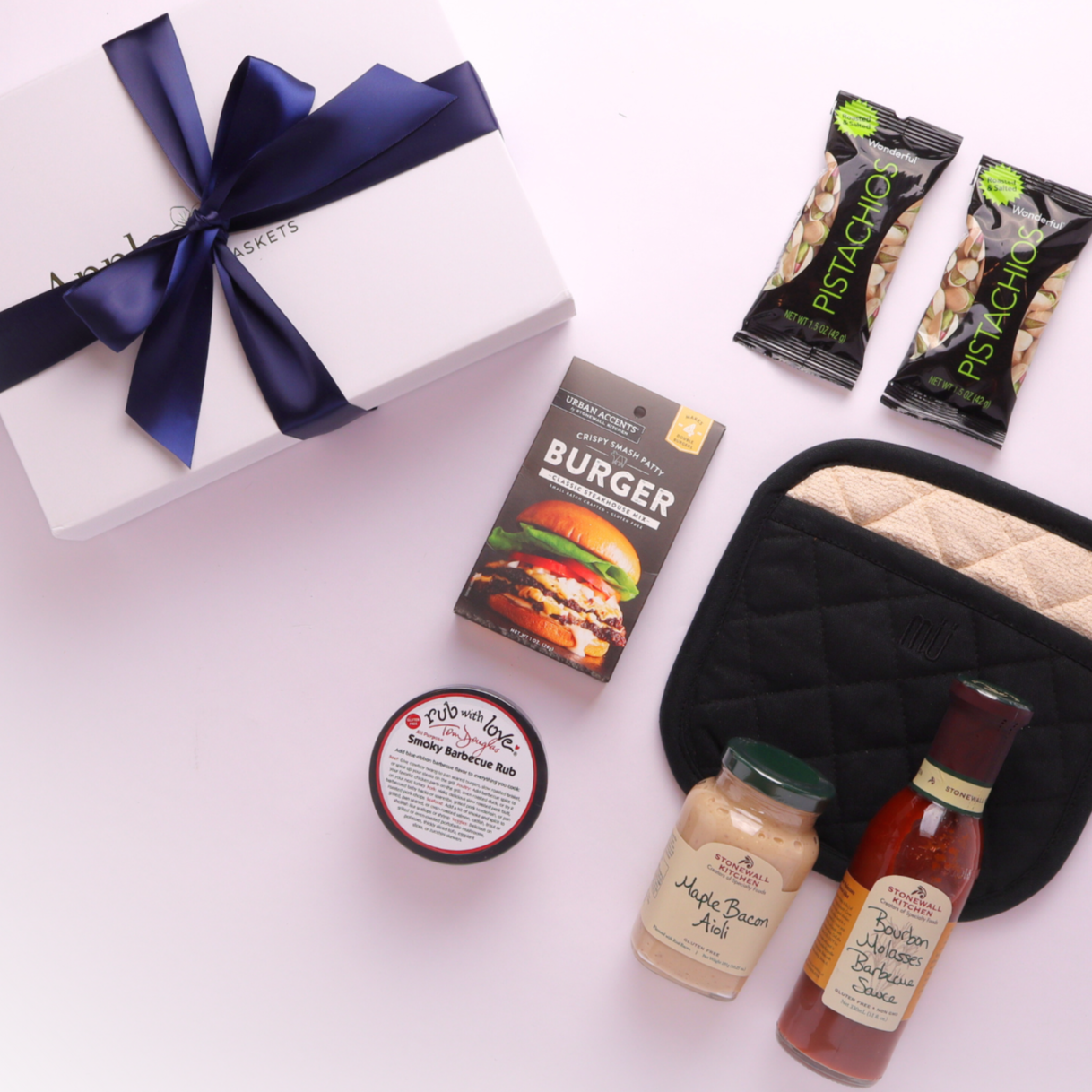 Beautifully styled gourmet BBQ gift box showcasing artisan sauces and local Seattle BBQ seasoning.