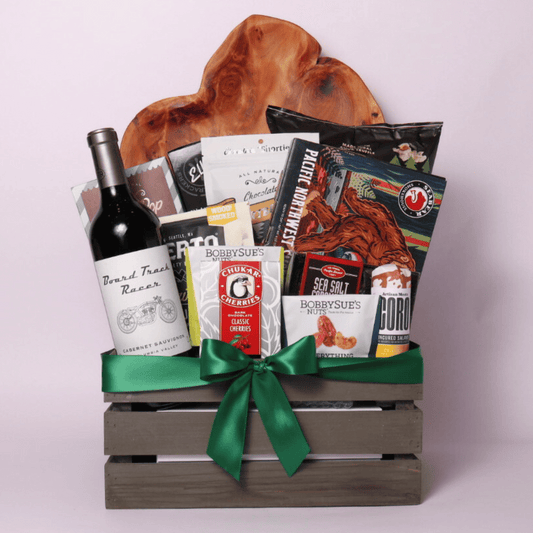 Best of the Northwest gift basket featuring artisan smoked salmon, Chocolate Cherries, gourmet nuts, handcrafted chocolate, popcorn, crackers, Florentina spritz, and other Pacific Northwest treats in a rustic wooden crate with a green satin bow.