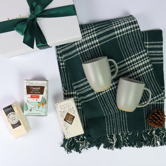 Thoughtful Christmas gift basket with a plaid throw, ceramic mugs, and sweet treats, all presented in a soft-touch luxury gift box. A great choice for client gifts or family holiday giftin