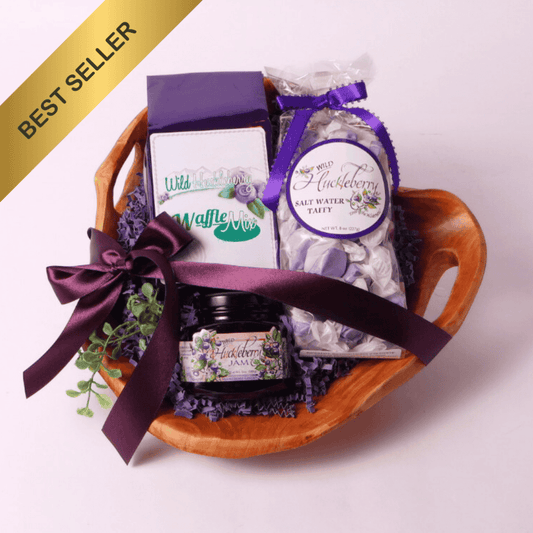 Handcrafted Washington Huckleberry Gift Basket – A beautifully arranged gift set featuring wild huckleberry jam, saltwater taffy, and waffle mix in a hand-carved, upcycled fir root wooden bowl. A unique gourmet gift!