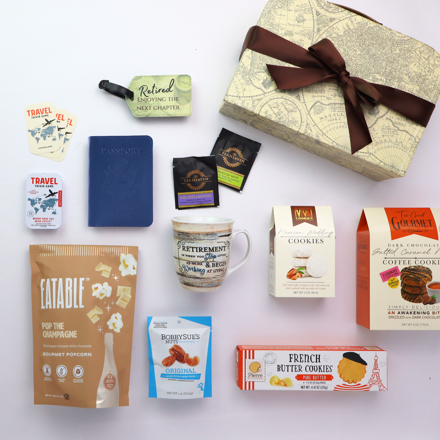 Collection of retirement gift basket items including a mug, snacks, and a decorative box on a white background