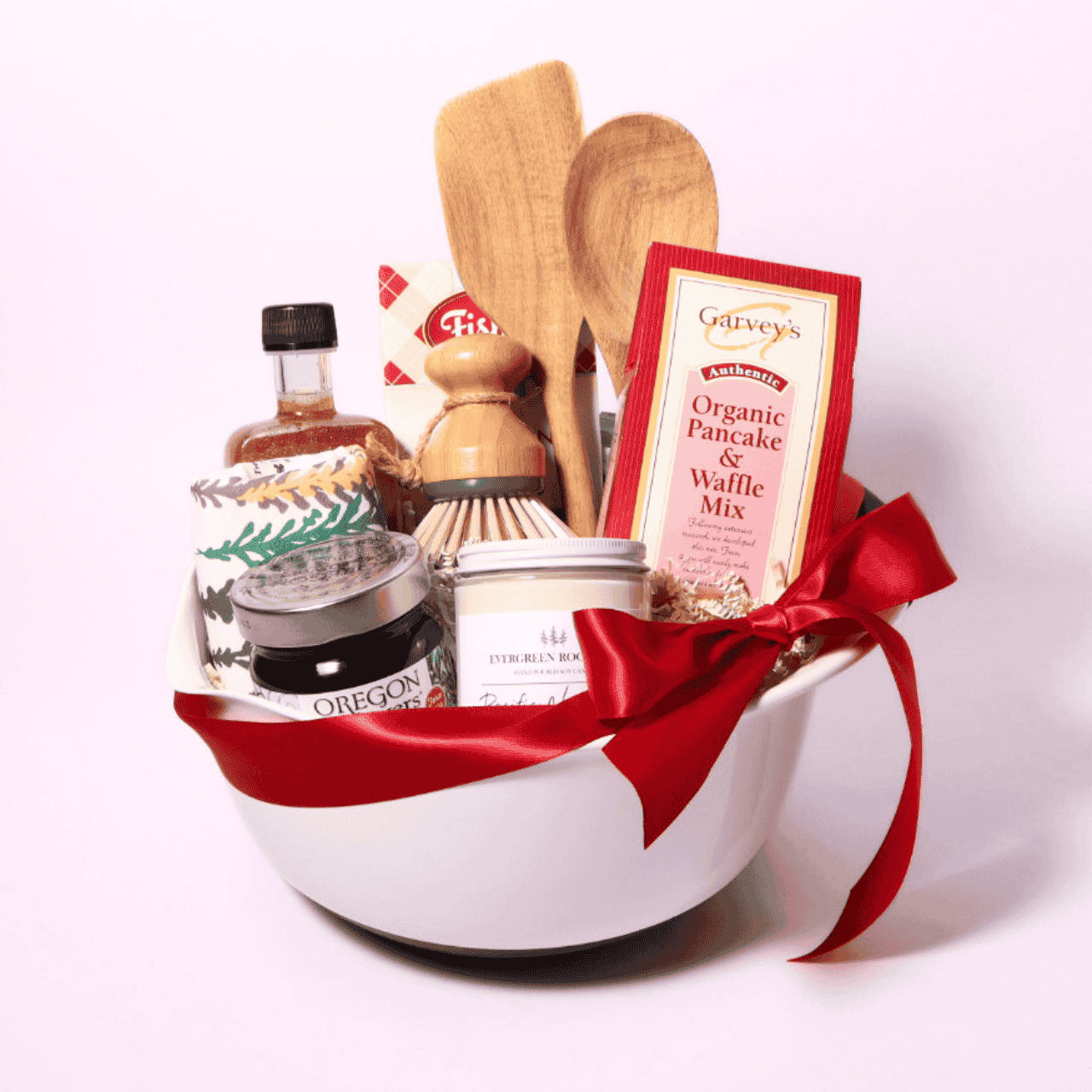 Breakfast gift basket with a 5-quart mixing bowl, Fisher Scone Mix, Marionberry Jam, Sparkle Maple Syrup, pancake mix, wooden kitchen utensils, dish towels, dish scrubber, and a Pacific Northwest candle for a cozy morning gift.