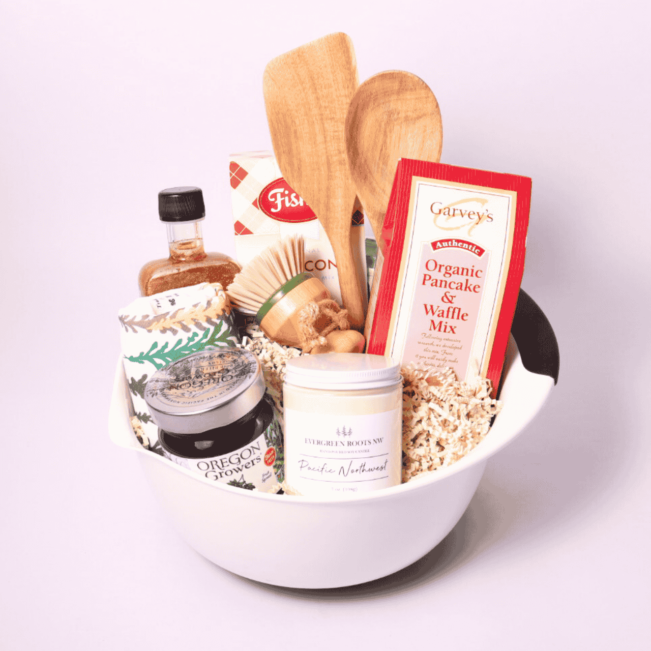 Gift basket for breakfast lovers with Fisher Scone Mix, organic pancake mix, Marionberry Jam, sparkling syrup, wooden utensils, a candle, and cozy dish towels—a taste of the Northwest for the perfect morning