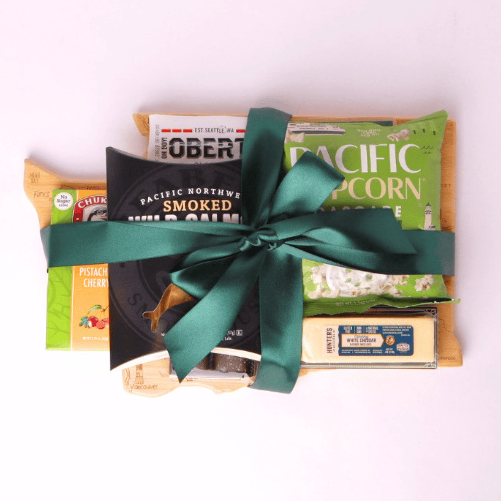 Washington Snack Board gift basket comes with a Washington state shaped bamboo cutting board, smoked salmon, cookies, crackers, chocolate caramels and candied nuts. Pacific Northwest Gift Baskets