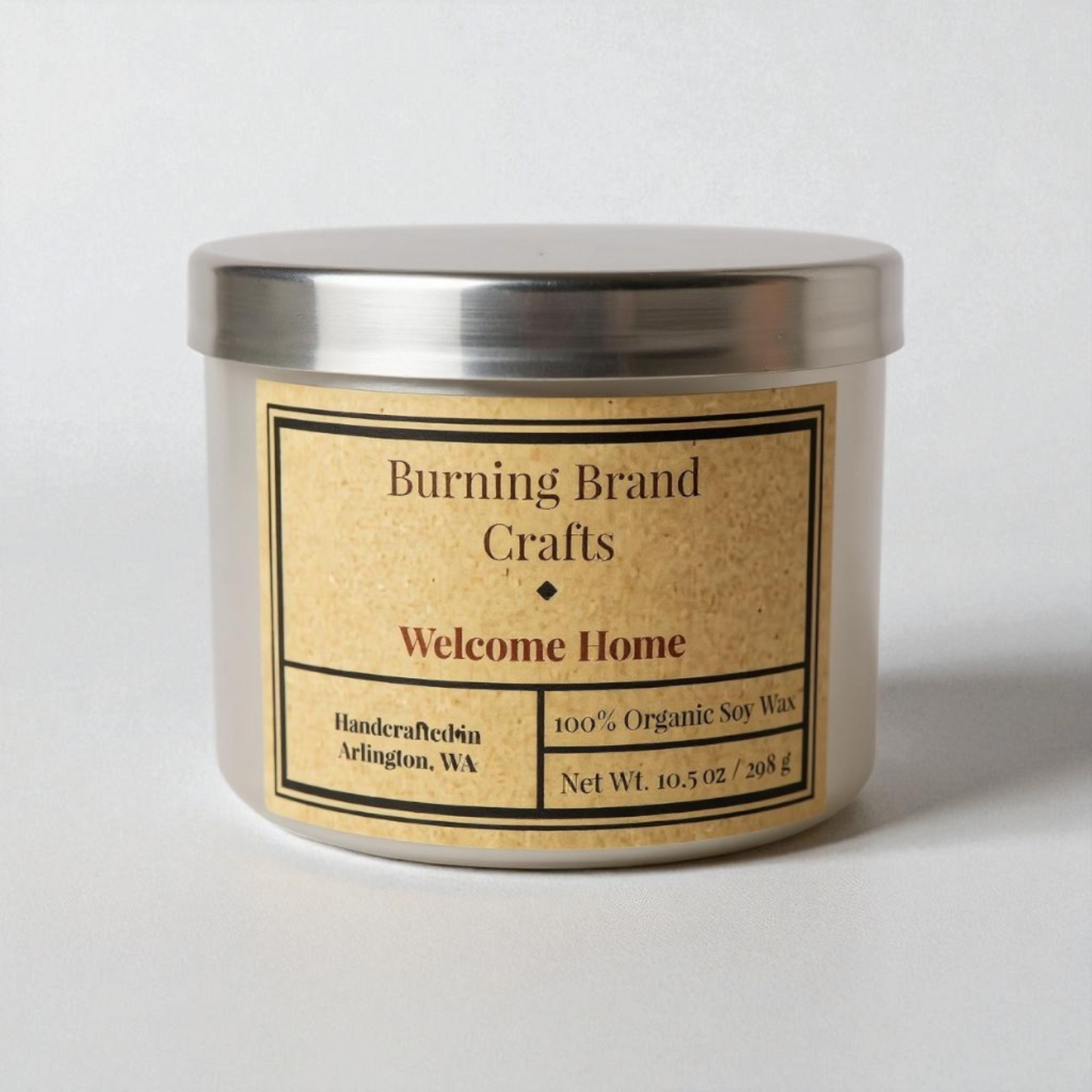 Candle with 'Burning Brand Crafts' label on a white background that says welcome home