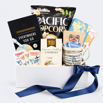 retirement gift box travel themed with snacks from around the world passport cover and luggage tag.