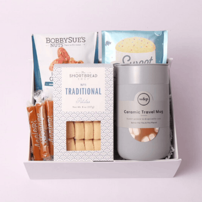 thank you gift box featuring a slate colored ceramic silicone wrapped mug, cookies, nuts, caramels and a mug cake.  Assembled in Washington and perfect client onboarding gift.