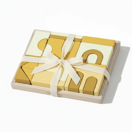 baby blocks gift Set of yellow wooden blocks with a white ribbon in a wooden box on a white background