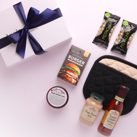 Beautifully styled gourmet BBQ gift box showcasing artisan sauces and local Seattle BBQ seasoning.