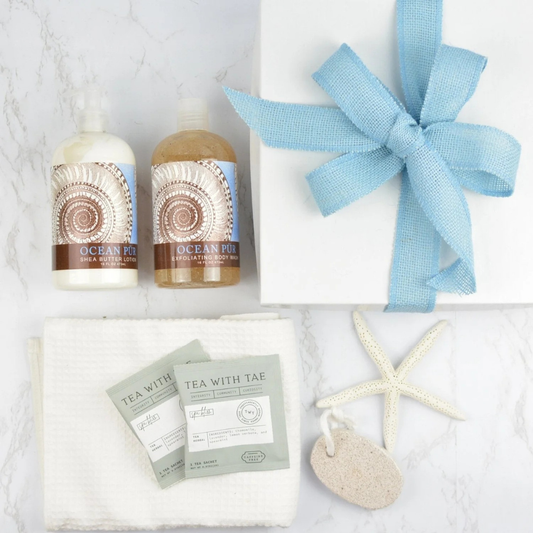 Gift set with 'Ocean pur' body butter, 'Tea with Tae' tea bags, and a starfish on a light background