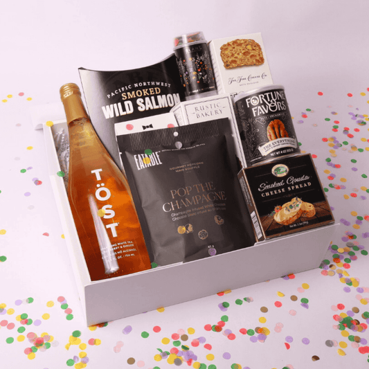 Celebrate in style with our luxurious champagne gift box featuring a bottle of sparkling white tea, pacific northwest smoked salmon, gourmet treats, and elegant pairings—perfect for any occasion, from weddings to corporate gifts.