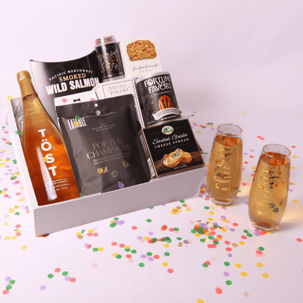 Raise a toast with our deluxe champagne and flute gift set! This elegant pairing of bubbly, artisanal snacks, and stylish glassware is perfect for engagements, New Year's, and milestone celebrations