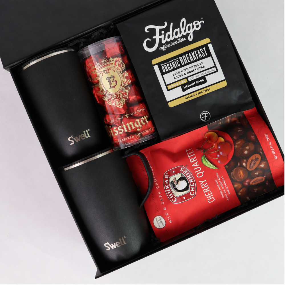 Open black coffee and chocolate gift box with S’well mugs, Fidalgo whole bean coffee, Bissinger’s chocolates and Chukar Cherry Quartet.