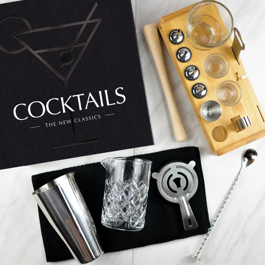 Bartending set with books and tools on a white surface