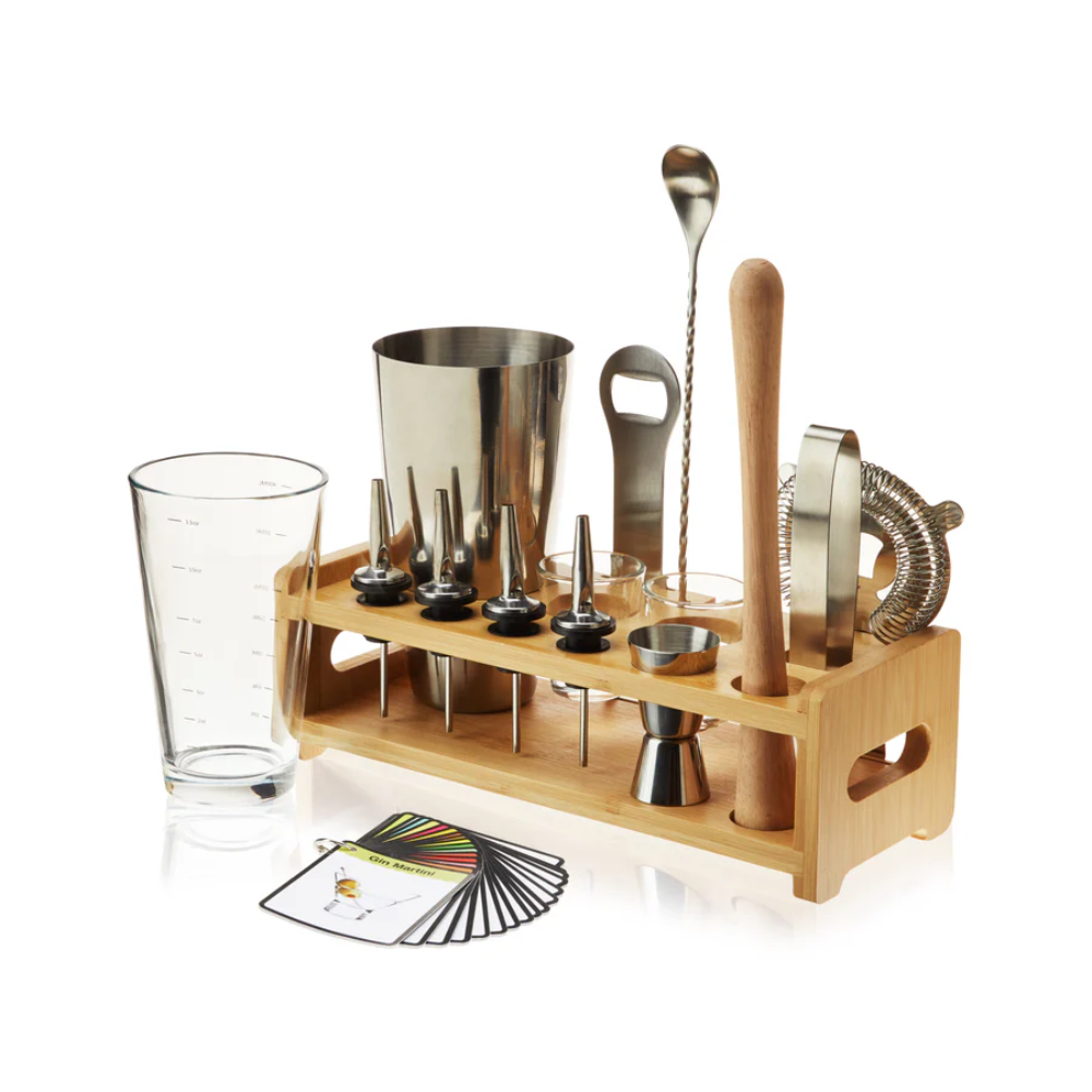 Set of bar tools including glasses, jiggers, and a wooden stand on a white background