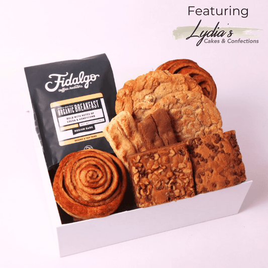 A beautifully curated coffee gift box featuring made in Washington artisan coffee, gourmet cookies, biscotti, brownies, and a freshly baked cinnamon roll—perfect for a thinking of you gift, birthday gift, or coffee drinker gift.