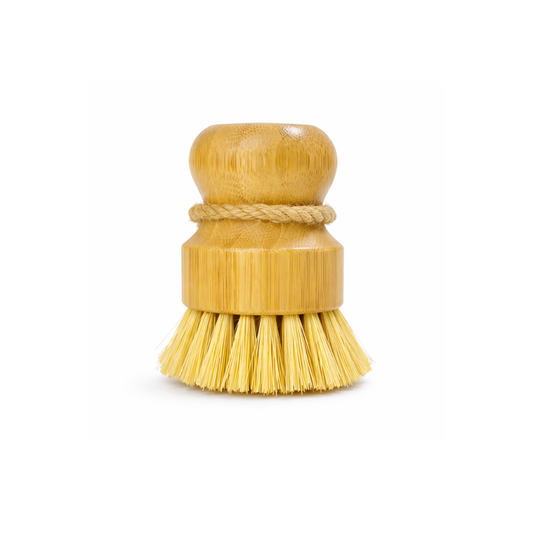 Wooden dish brush with yellow bristles on a white background