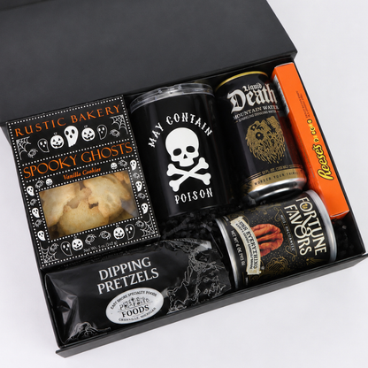 Open black Halloween gift box filled with ghost cookies, Reese’s Pieces, pretzels, gourmet nuts, sparkling water and spooky tumbler.