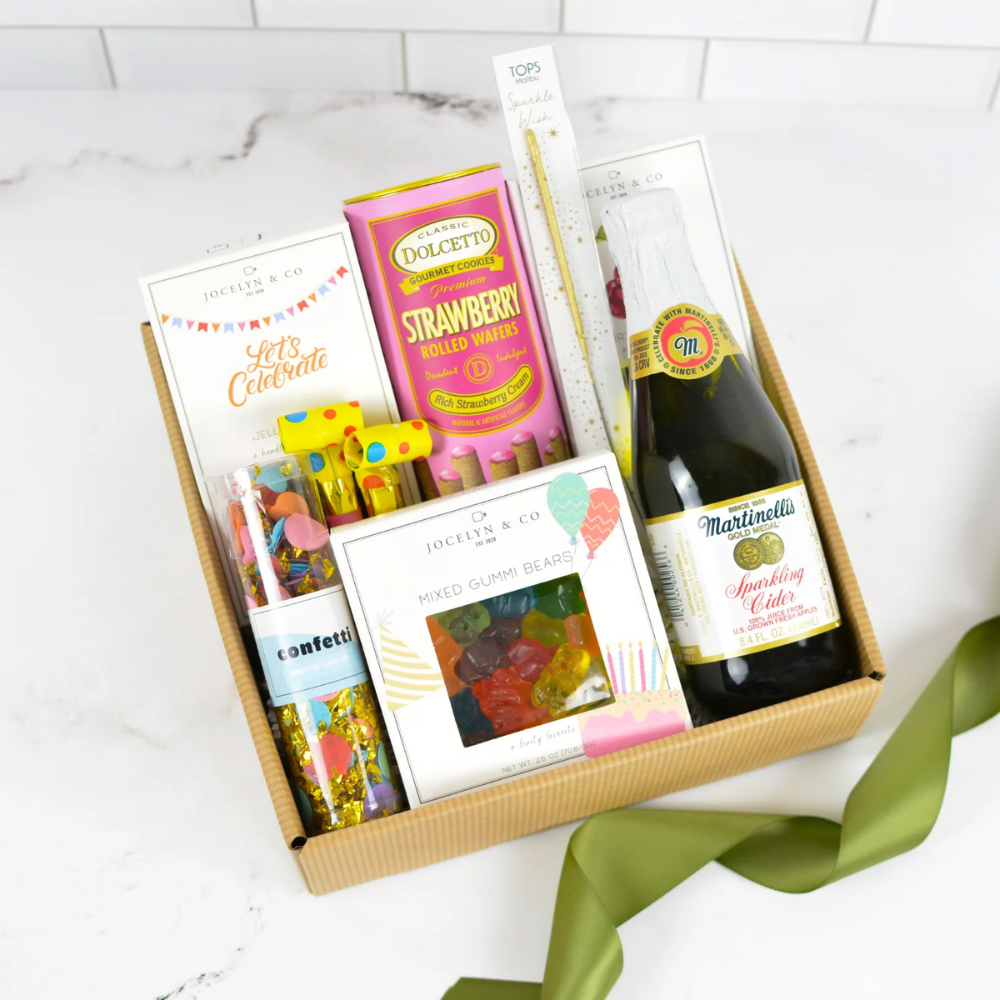 Let’s Celebrate gift basket with sparkling cider, gourmet snacks, gummies, and festive party accents by Apple Blossom Gift Baskets.