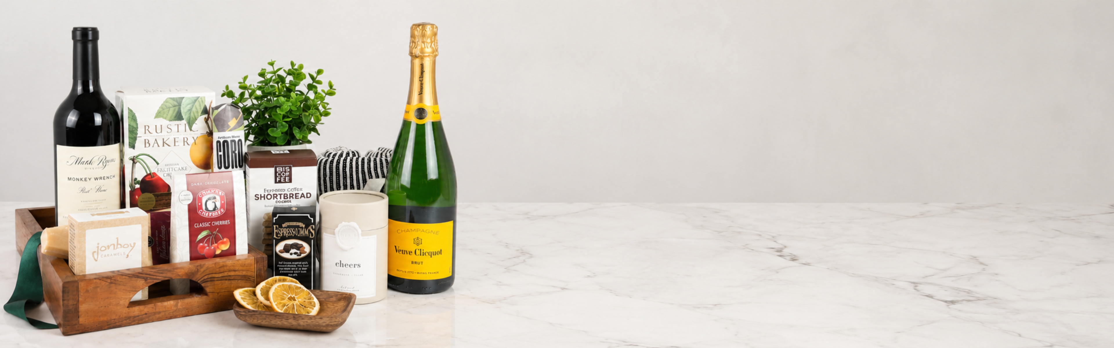 Luxury Pacific Northwest gift basket with wine, champagne, artisan foods, and gourmet gifts on a marble countertop.