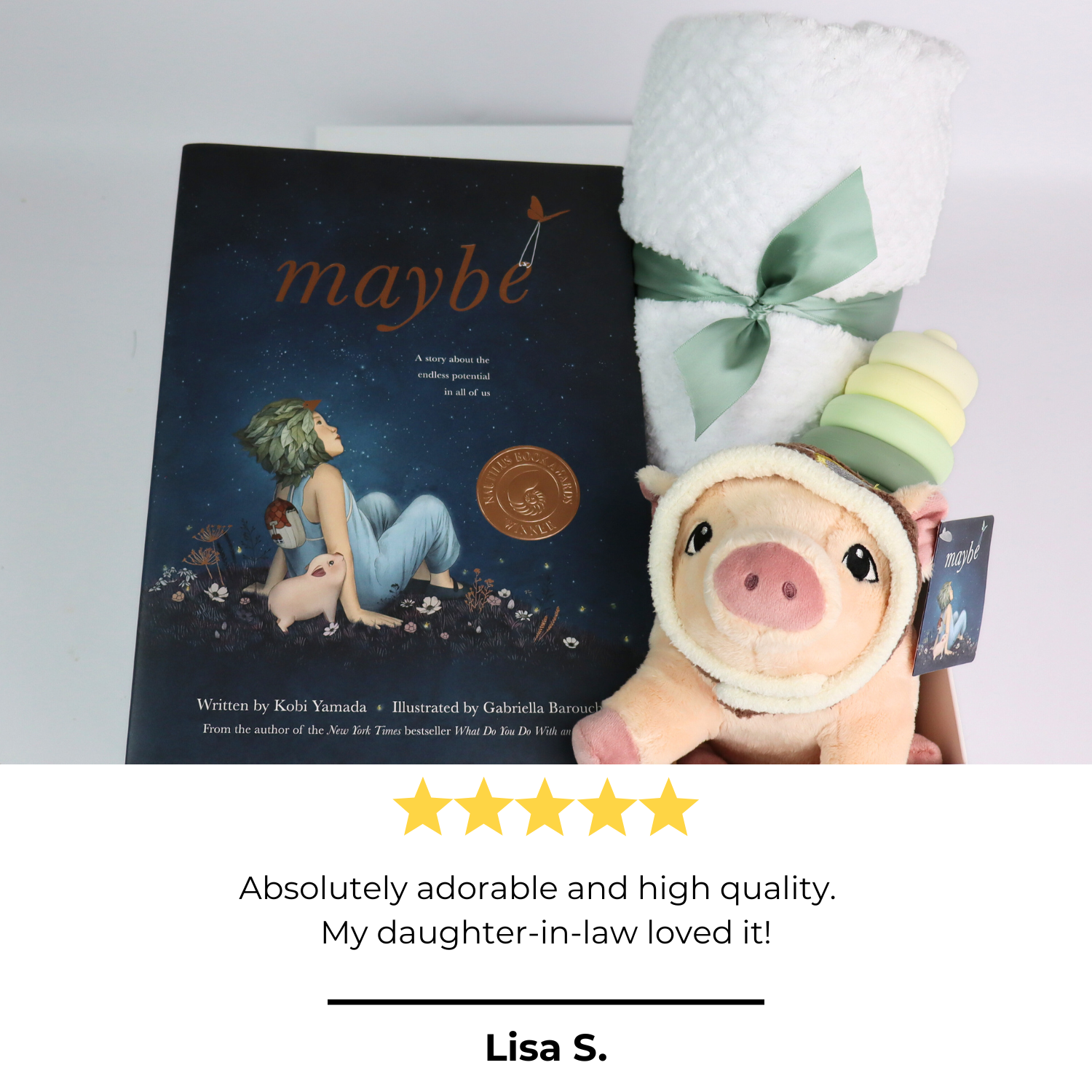 baby gift box with Book titled 'maybe' with a plush toy and baby blanket on a light gray background