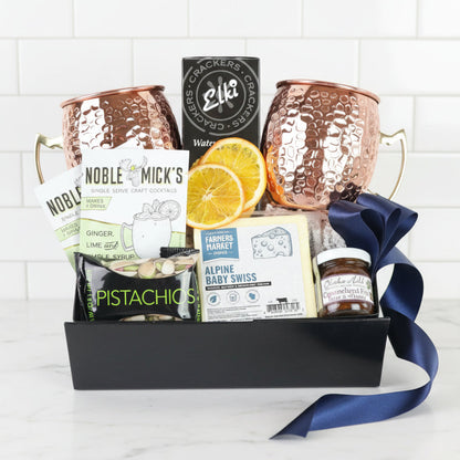 moscow mule Gift basket with copper mugs, snacks, and moscow mule mix on a white background