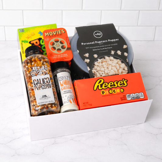 Gift box fully assembled with popcorn popper, movie snacks, trivia game, popcorn seasoning, and seed – perfect movie night gift for families or friends.