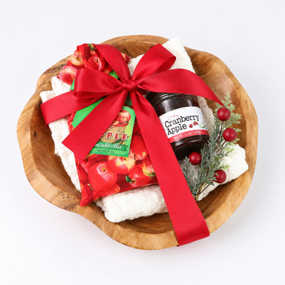 Top view of Northwest Christmas Morning gift bowl wrapped with a red satin ribbon in a reusable natural wood bowl