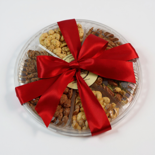 Round gourmet nut gift tray tied with a red satin bow, featuring roasted and seasoned nuts for corporate or holiday gifting.