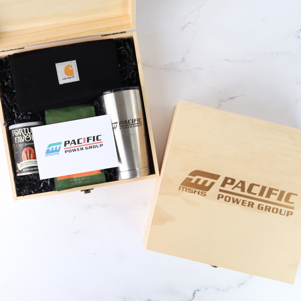 Custom corporate gift box for male-dominated industry with stainless steel tumbler, black beanie, gourmet snacks and personalized message card.