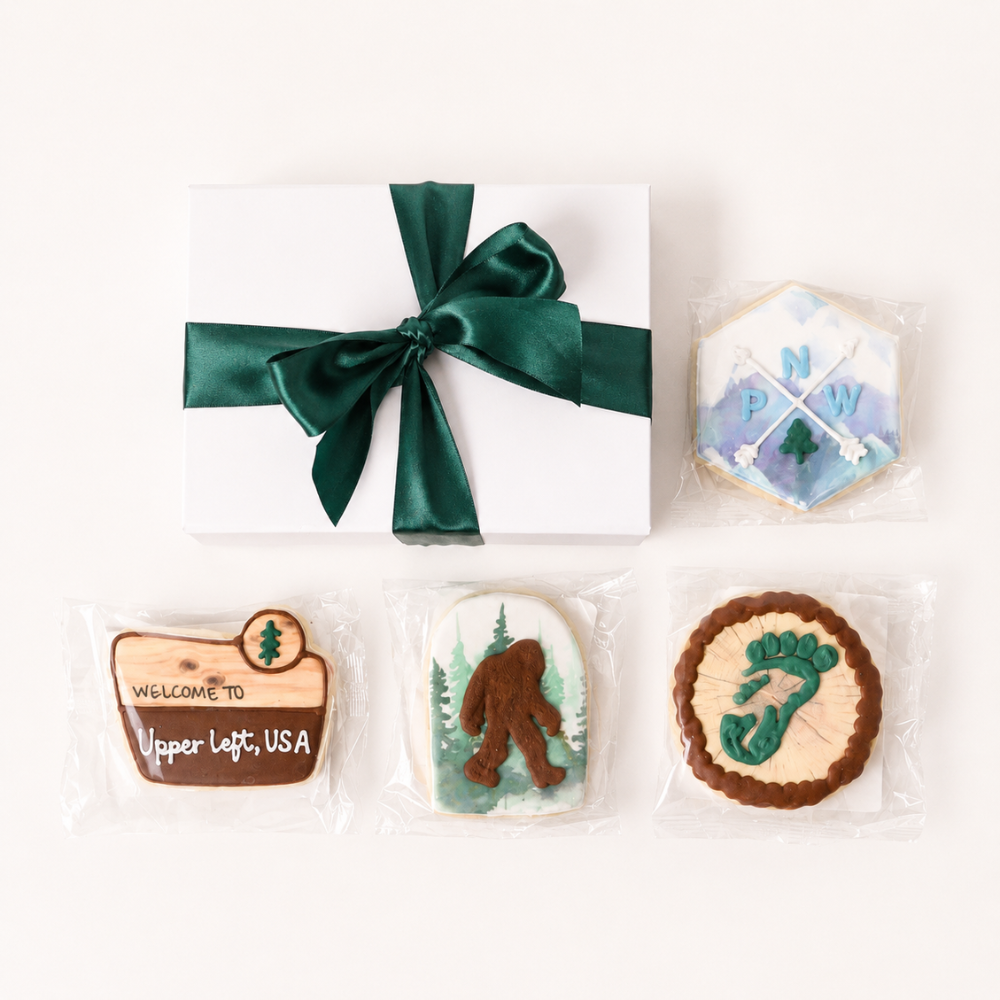 Pacific Northwest Cookie Gift Box with individually wrapped Seattle-inspired cookies and white gift box with green ribbon