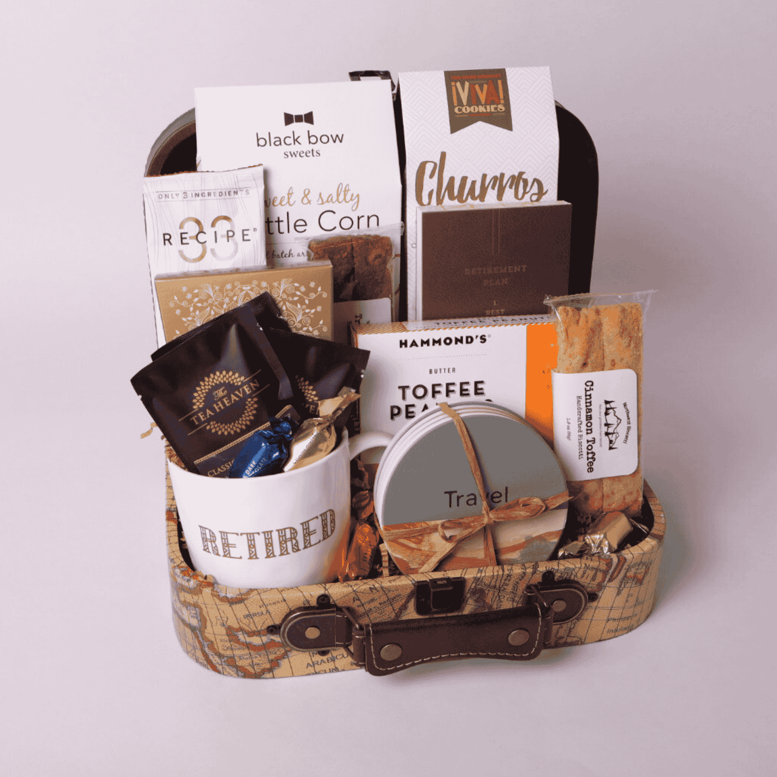 retirement gift basket with travel themed snacks and accessories.  The decorative mini suitcase includes a coffee mug, travel notebook, stone coasters popcorn, coffee, cookies and travel snacks.  Perfect retirement gift for her or for him.
