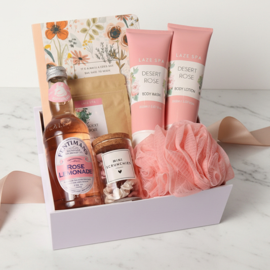 Gift set with body wash, lotion, lemonade bottle, and other items on a white background