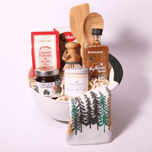 Gourmet baking breakfast gift basket featuring Pacific Northwest scone mix, sparkling maple syrup, Marionberry jam, and pancake mix with dish towels and kitchen utensils—a perfect gift for breakfast lovers