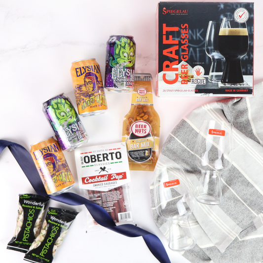 Assorted snacks and elysian seattle beer-related items including cans, a box of glasses, and a bag of chips on a white background