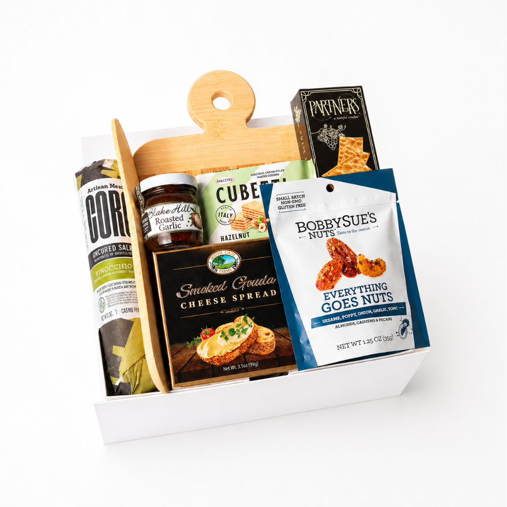 Simply Savory Gift Box featuring a bamboo paddle board, spreading knife, gourmet crackers, salami made in WA, cheese spread, savory jam, nuts, and hazelnut wafer cookies, perfect for hostess or housewarming gifts.