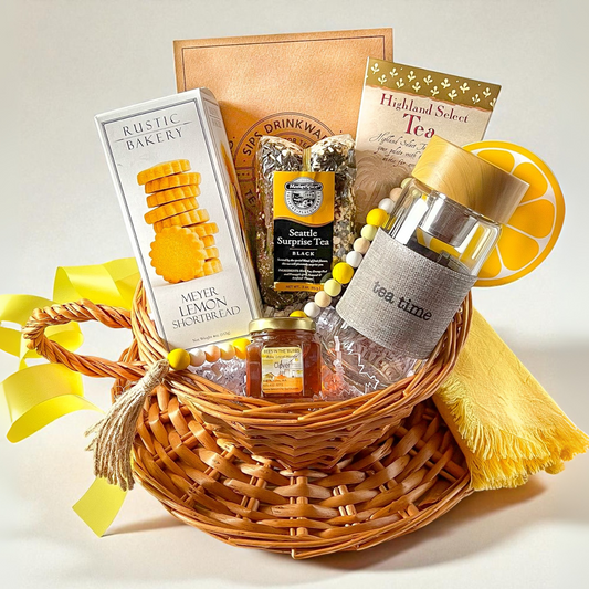 local Seattle tea, cookies, tea accessories and tea infuser bottle all in a cup and saucer shaped gift basket.