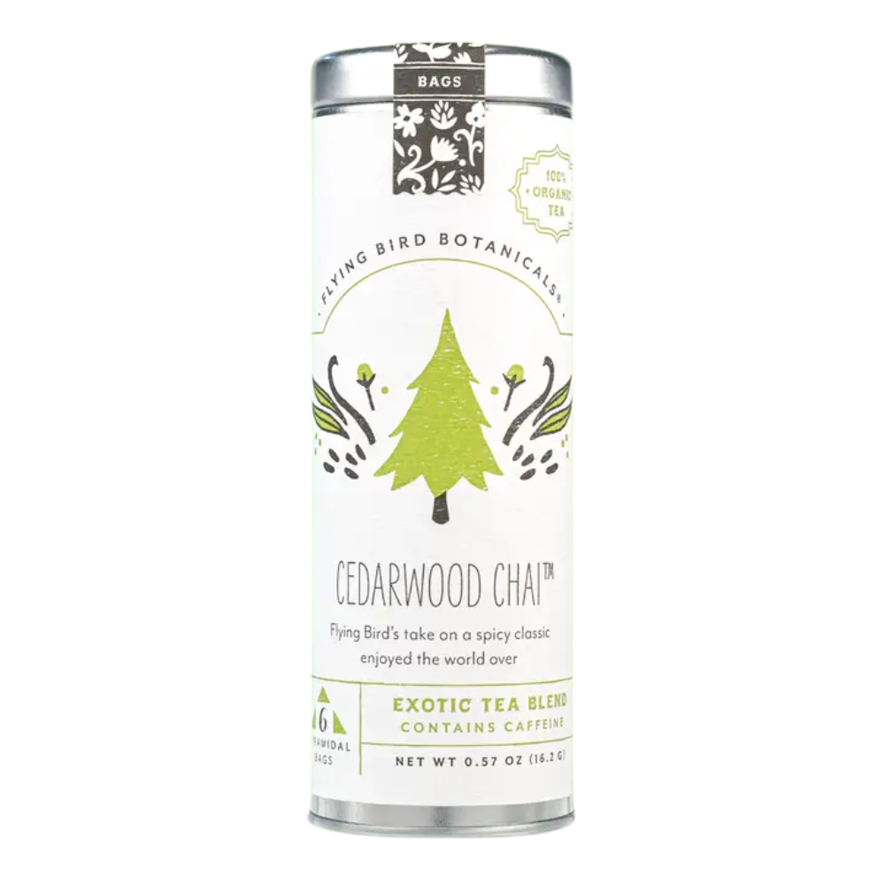 Flying Bird Botanicals Cedarwood Chai organic black tea in a decorative tin featuring an evergreen tree illustration, made in Washington State.