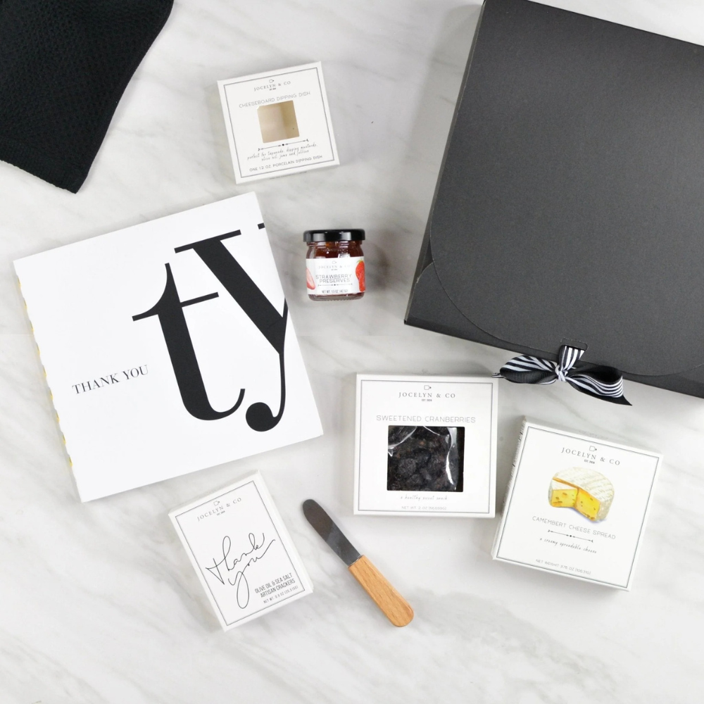 A Simple Thank You gift box with gratitude book, gourmet crackers, cheese, jam, and black ribbon gift box