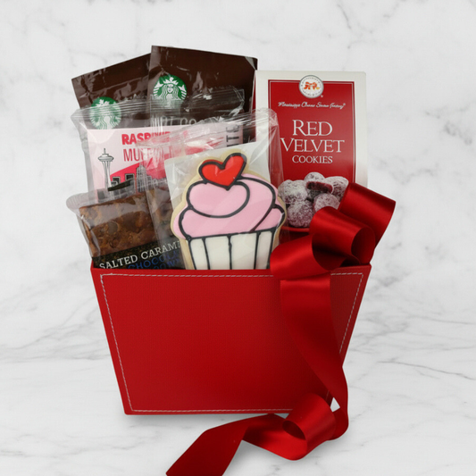 Gift basket with red velvet cookies, starbucks drinks, and a cupcake-shaped cookie on a white background