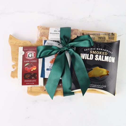 Washington Snack Board gift basket comes with a Washington state shaped bamboo cutting board, smoked salmon, cookies, crackers, chocolate caramels and candied nuts.   Pacific Northwest Gift Baskets