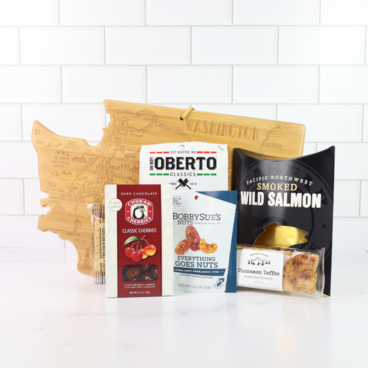 Washington Snack Board gift basket features products made in Washington and comes with a Washington state shaped bamboo cutting board, smoked salmon, cookies, crackers, chocolate caramels and candied nuts. Apple Blossom Gift Baskets