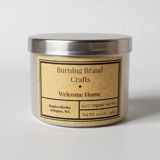 Candle with 'Burning Brand Crafts' label on a white background that says welcome home