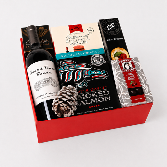 Wine and snack gift box with red wine, smoked salmon, chocolate cherries, crackers, cookies, and cheese spread