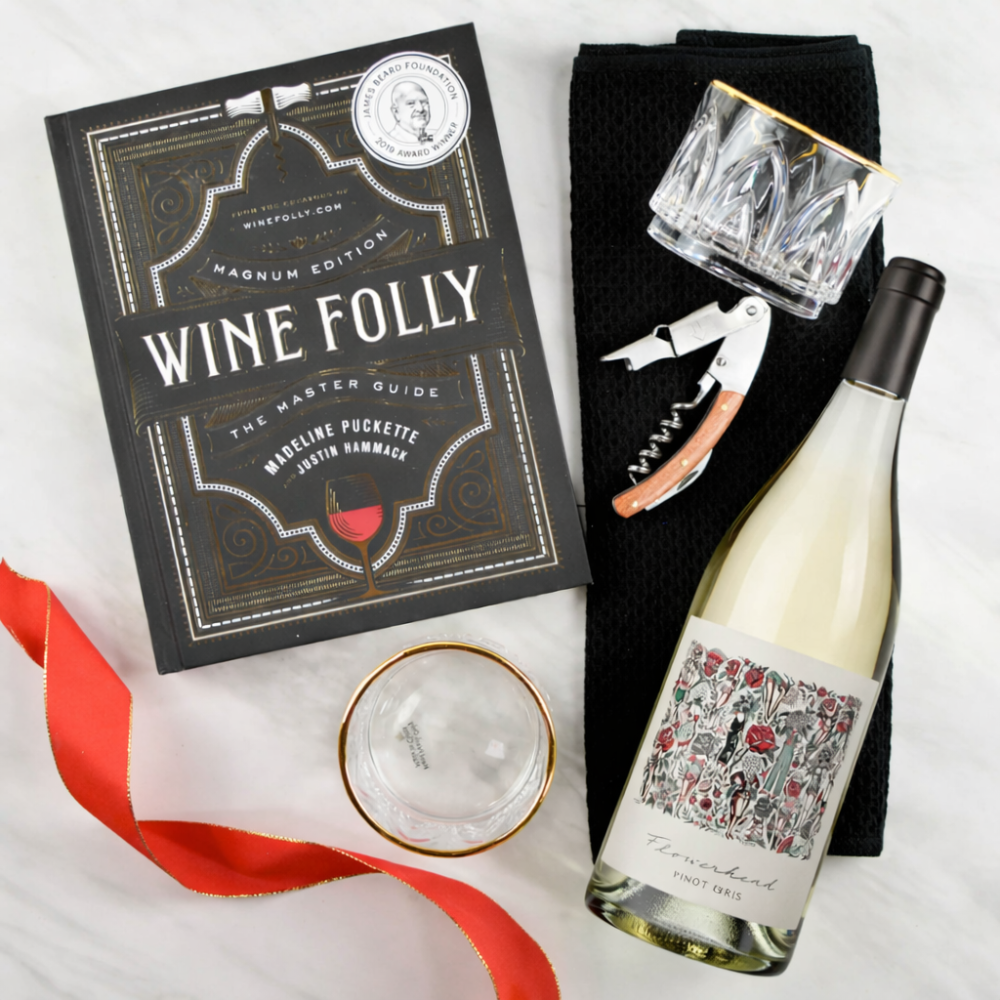 Wine bottle, 'Wine Folly' book, glasses, and corkscrew on a white background with mark ryan pinot gris