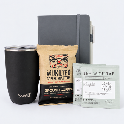 Workday Essentials gift set featuring black S'well insulated tumbler, gray notebook, Mukilteo ground coffee and Tea with Tae herbal tea sachets.